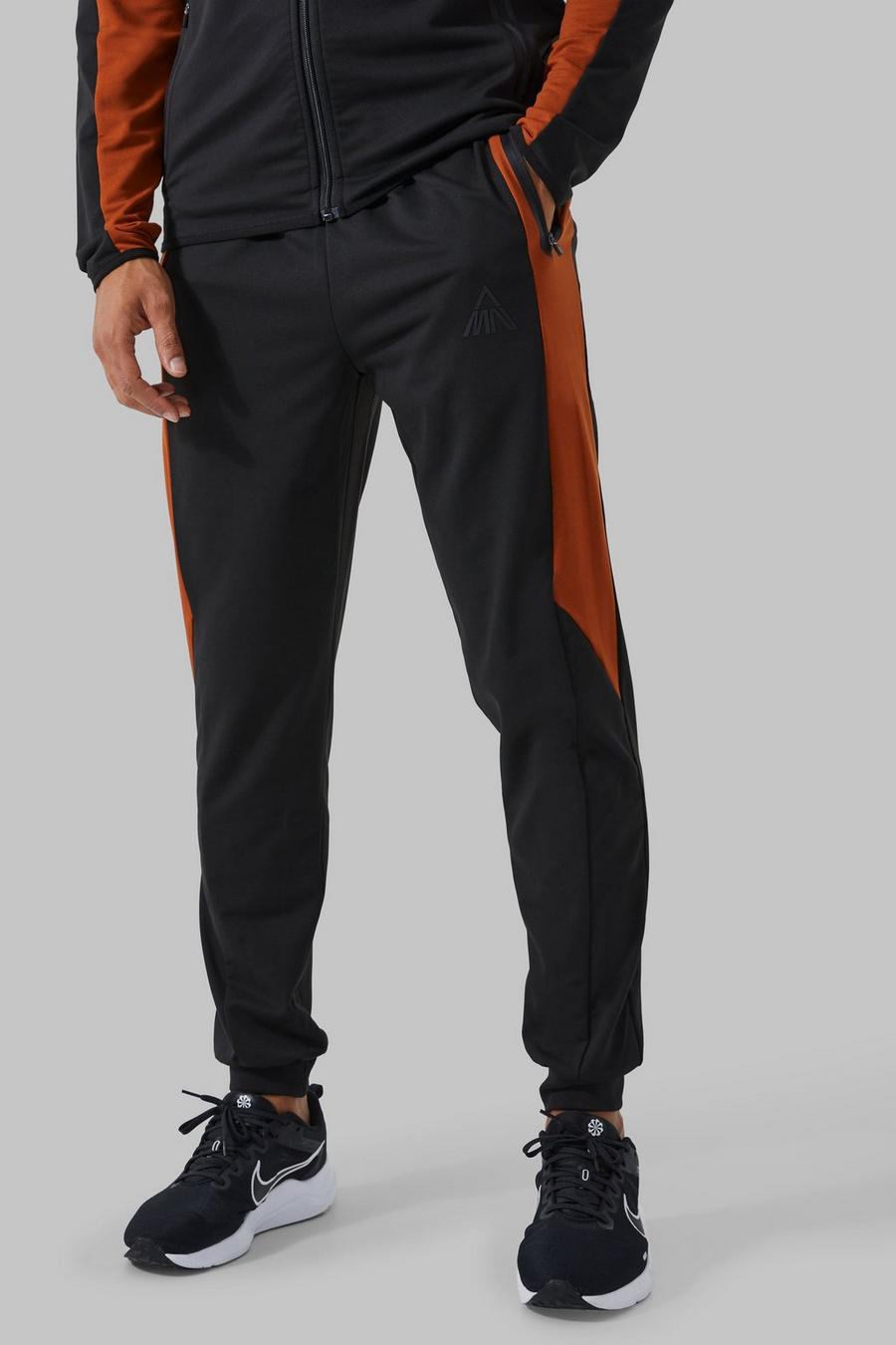 Pantaloni tuta Man Active a blocchi di colore con pannelli, Burnt orange