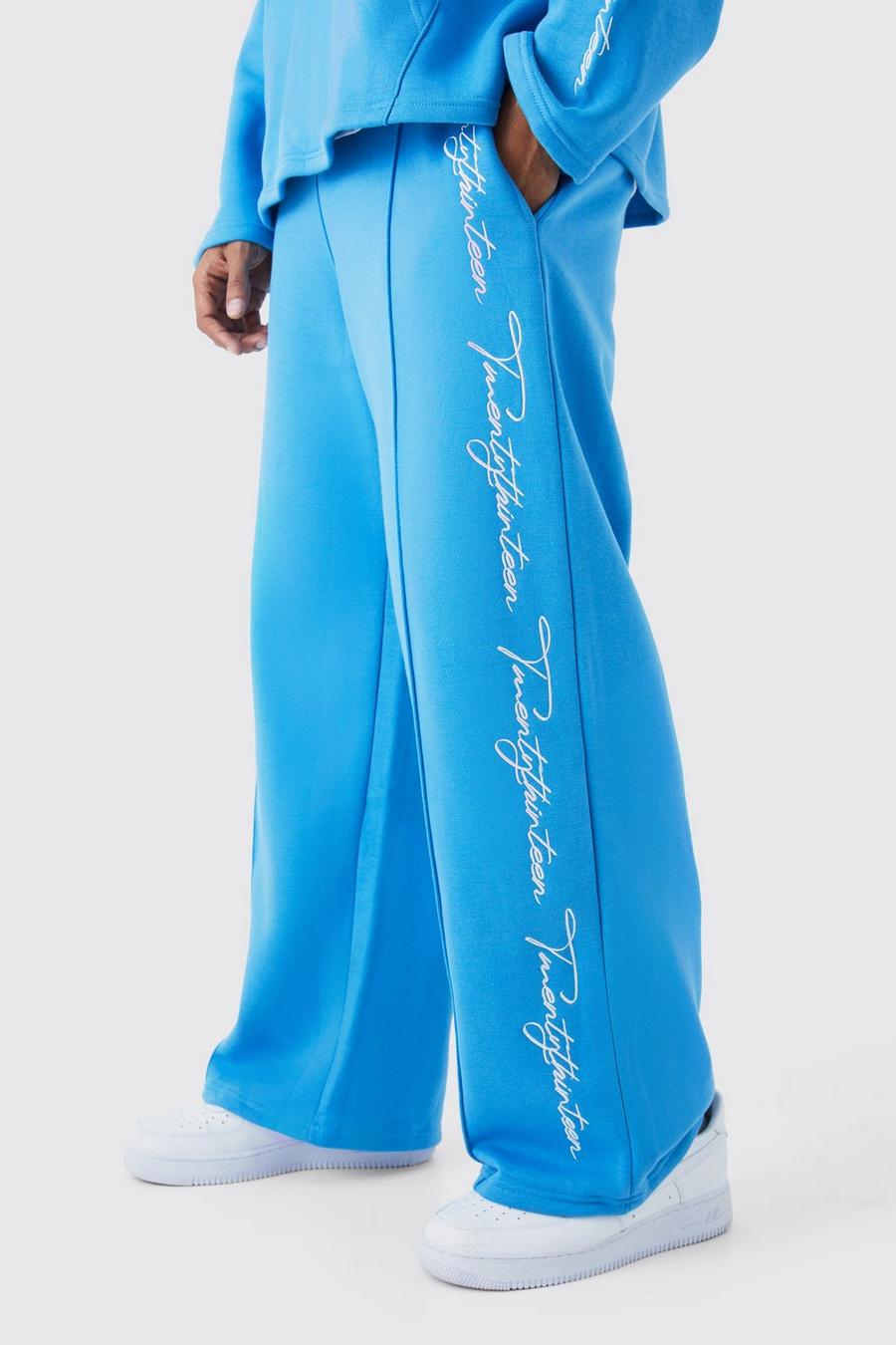 Pantaloni tuta a gamba ampia con scritta ricamata e fondo grezzo, Blue
