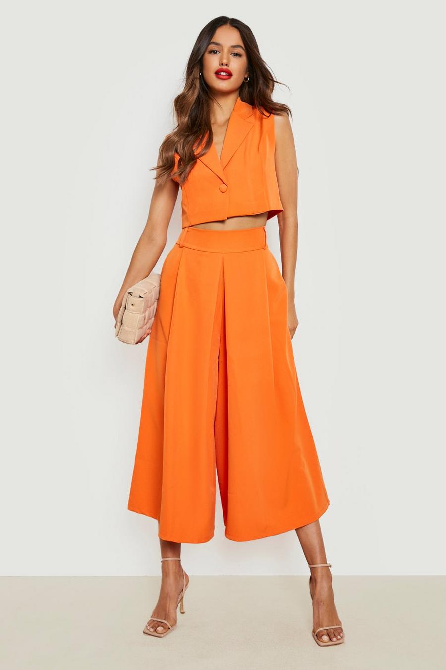 Orange Kostymbyxor med vida ben och dekorativa veck