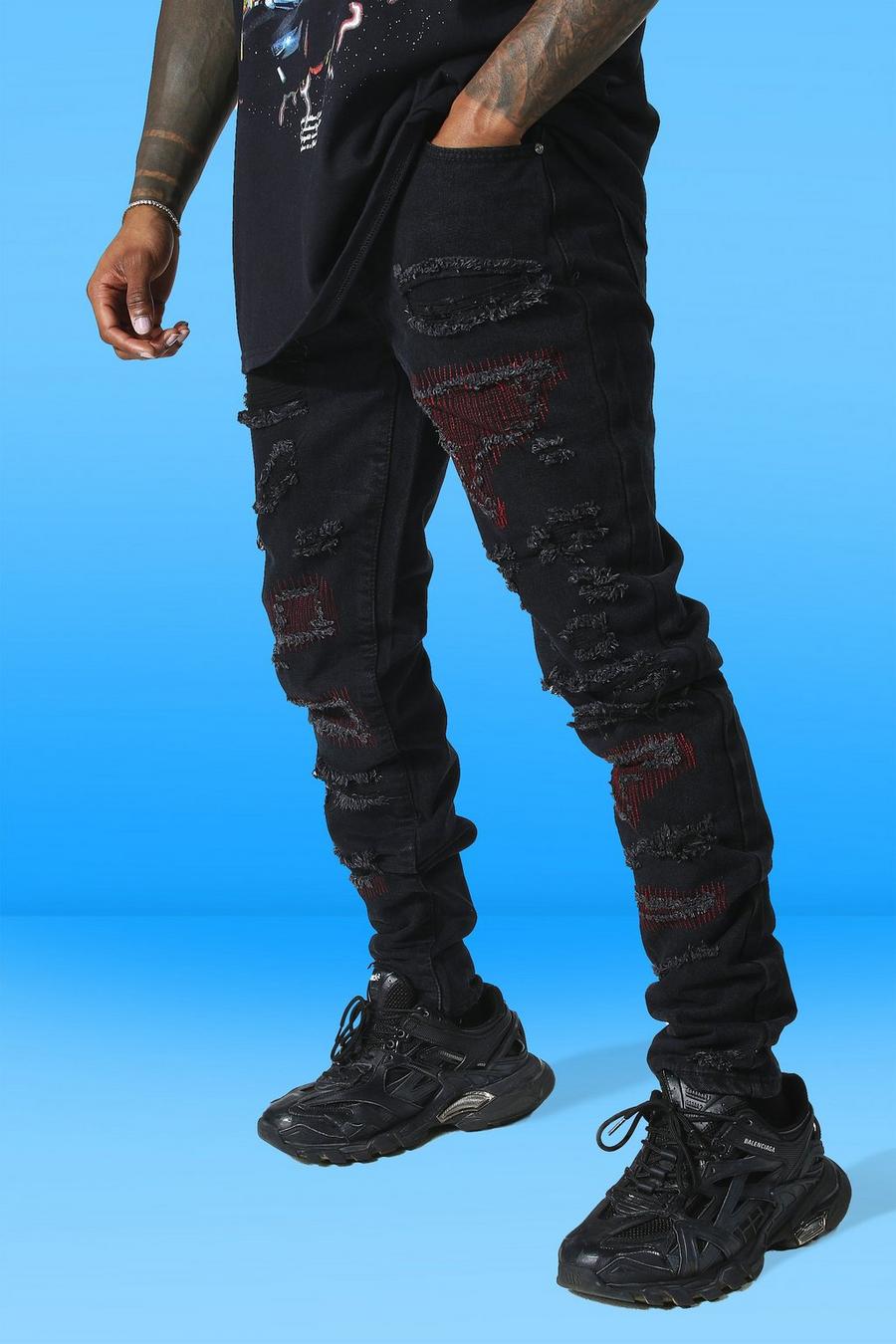 שחור ג׳ינס בגזרת קרסול צרה עם קצוות נערמים, הדפס חוזר וקרעים image number 1