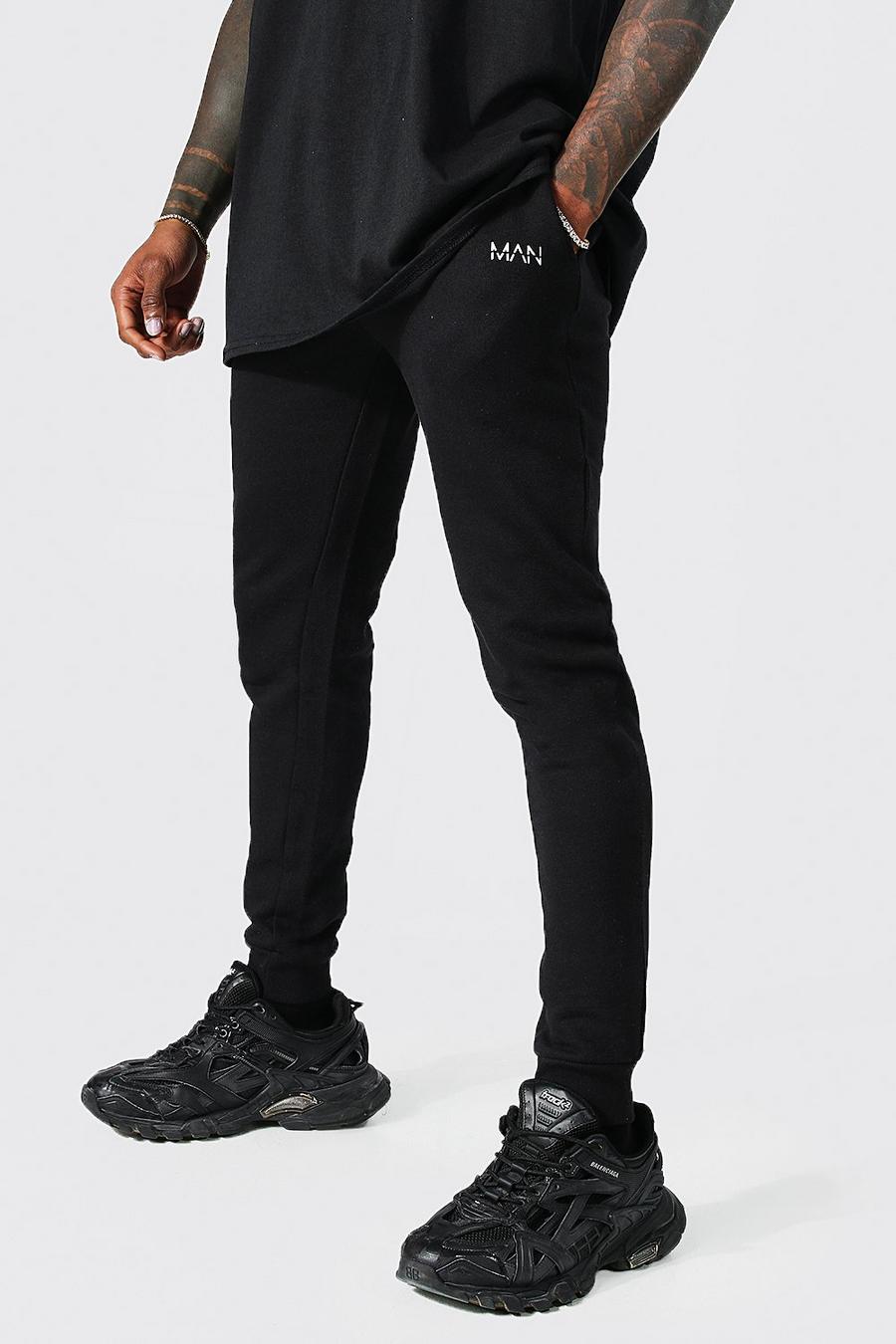 Pantalón deportivo súper pitillo con letras MAN, Black nero image number 1