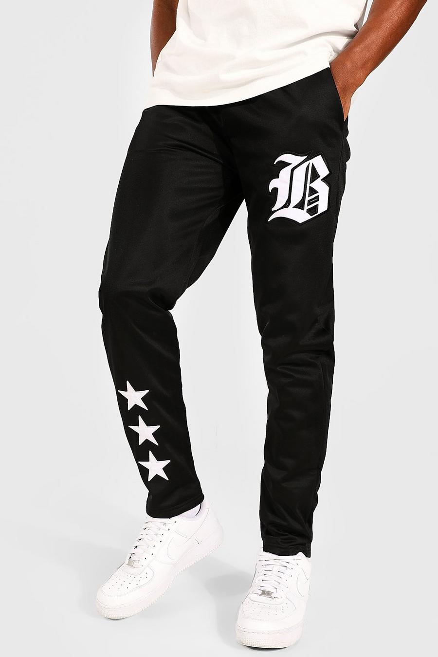 Pantalón deportivo Regular de tejido por urdimbre universitario con emblema, Black negro image number 1