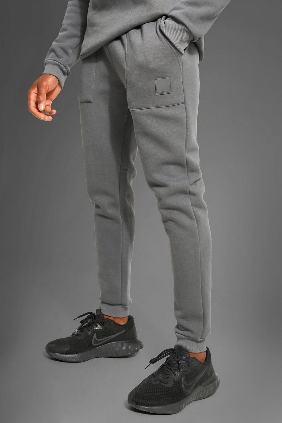 פחם grigio מכנסיים ספורטיביים לחדר הכושר עם כיסים וכיתוב Man