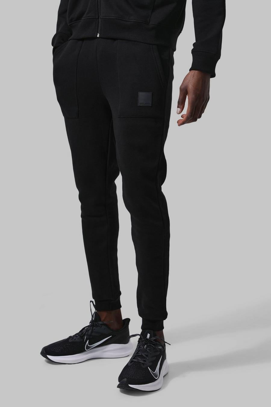 שחור מכנסיים ספורטיביים לחדר הכושר עם כיסים וכיתוב Man image number 1