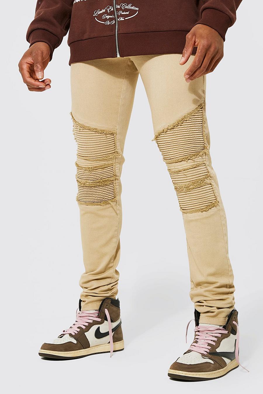 אבן beige סקיני ג'ינס אופנוענים עם קרעים ושוליים נערמים ועם רוכסן
