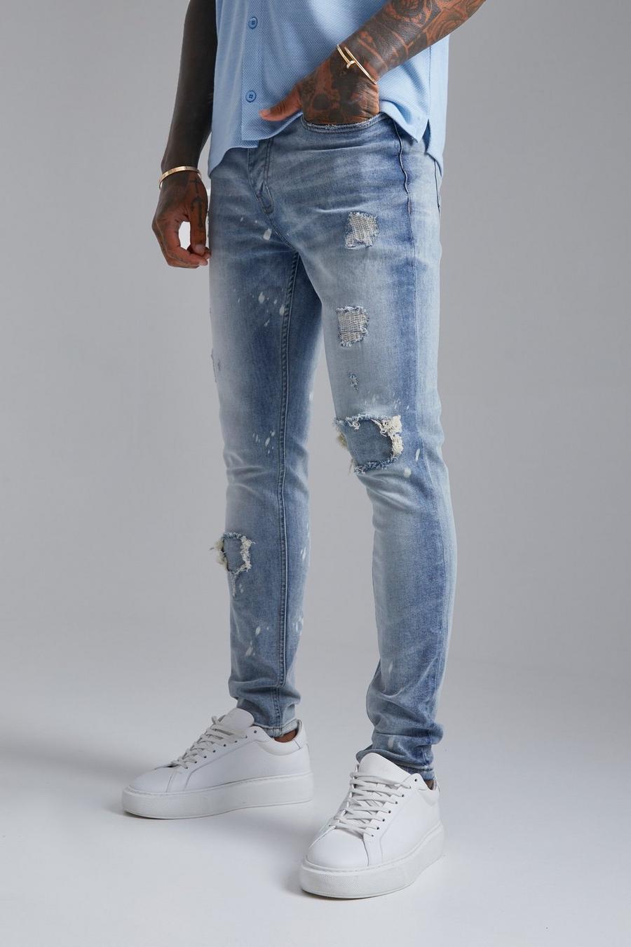 כחול בהיר סקיני ג'ינס סטרץ' עם קרעים וטלאים וכתמים מולבנים image number 1