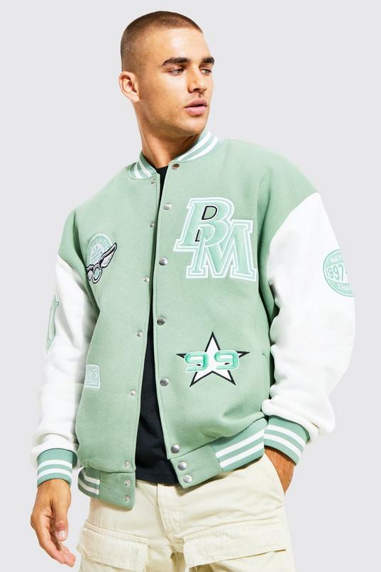 Mennace varsity bomber jacket in forest green with multiple badges and  monogram sleeves