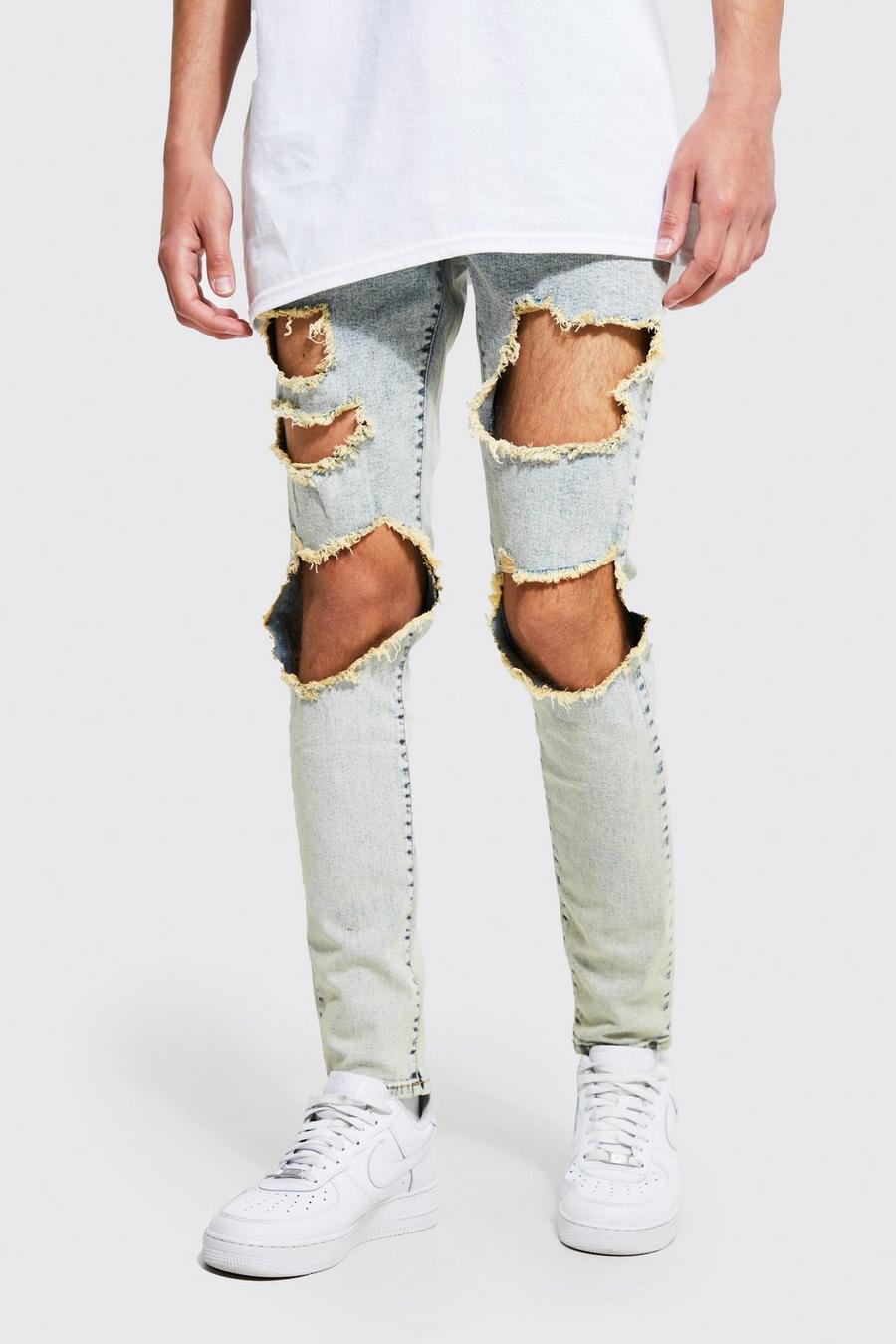 כחול עתיק ג'ינס סקיני סטרץ' עם קרעים גדולים מרובים בברך