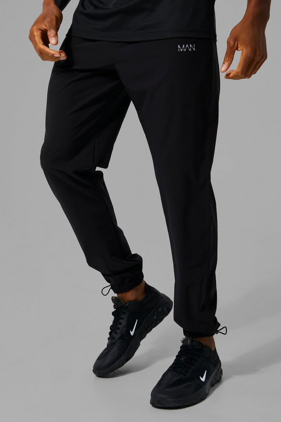 Pantalón deportivo MAN Active con alamar en el bajo y cordón elástico, Black image number 1