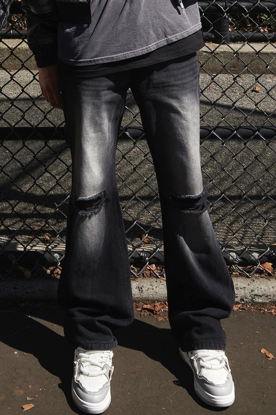 Washed black Utsvängda jeans med slitna knän