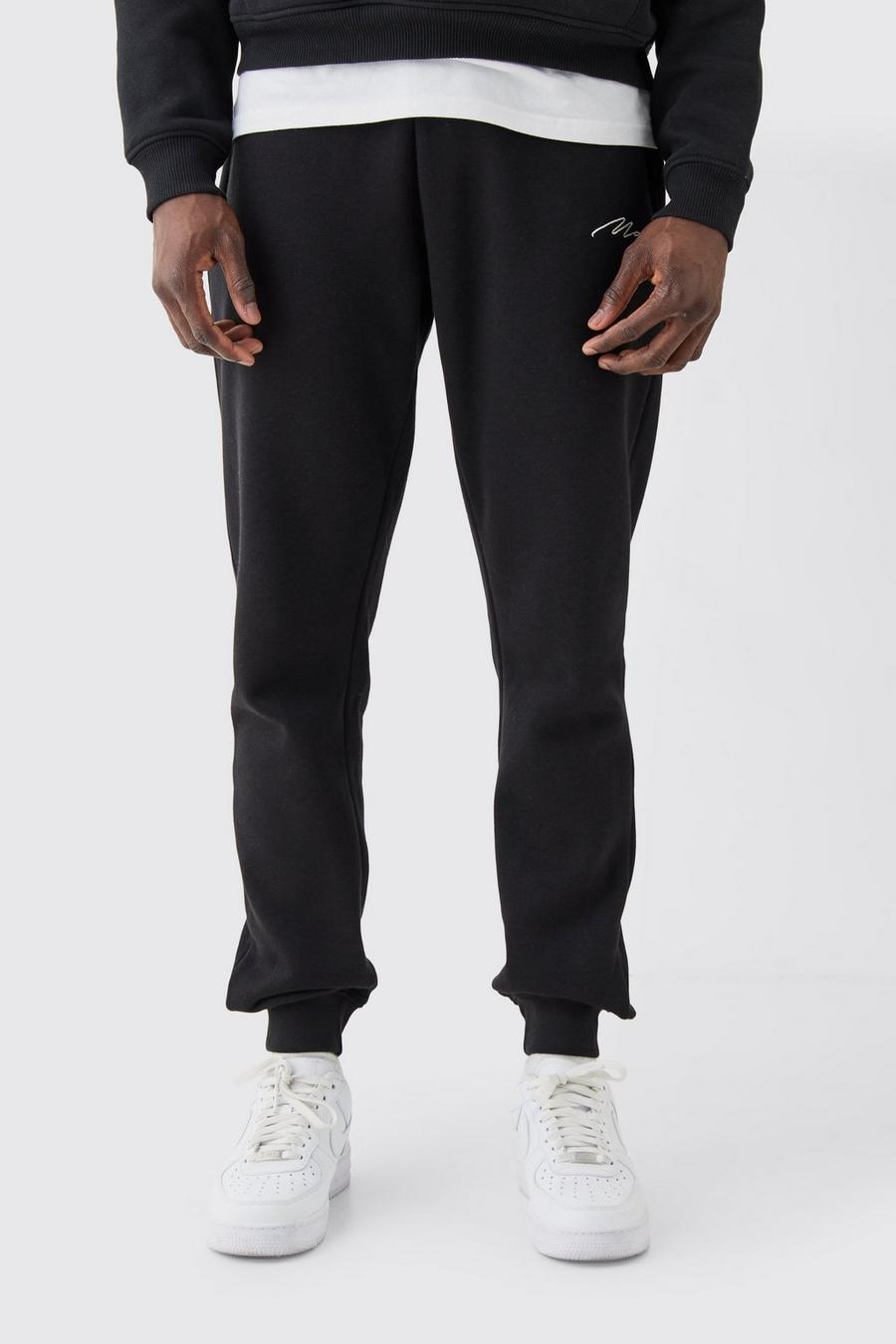 Pantalón deportivo pitillo con firma MAN, Black image number 1