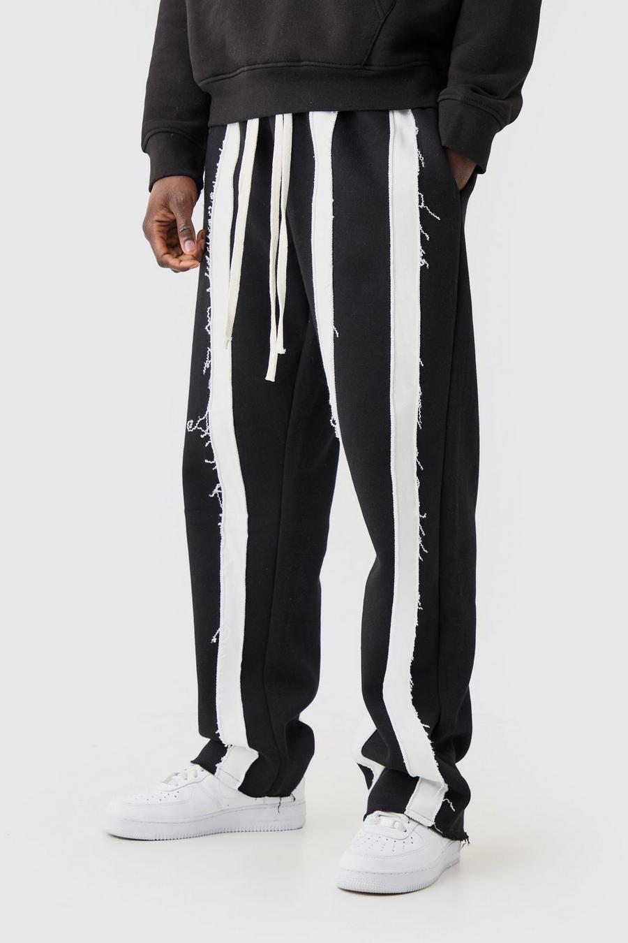 Pantalón deportivo holgado de rayas con costuras y filos sin acabar, Black image number 1