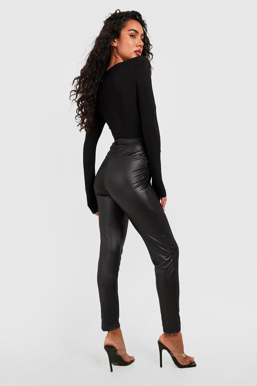 Cutie donning high waisted faux Leather Leggings, Heels and Tattoos