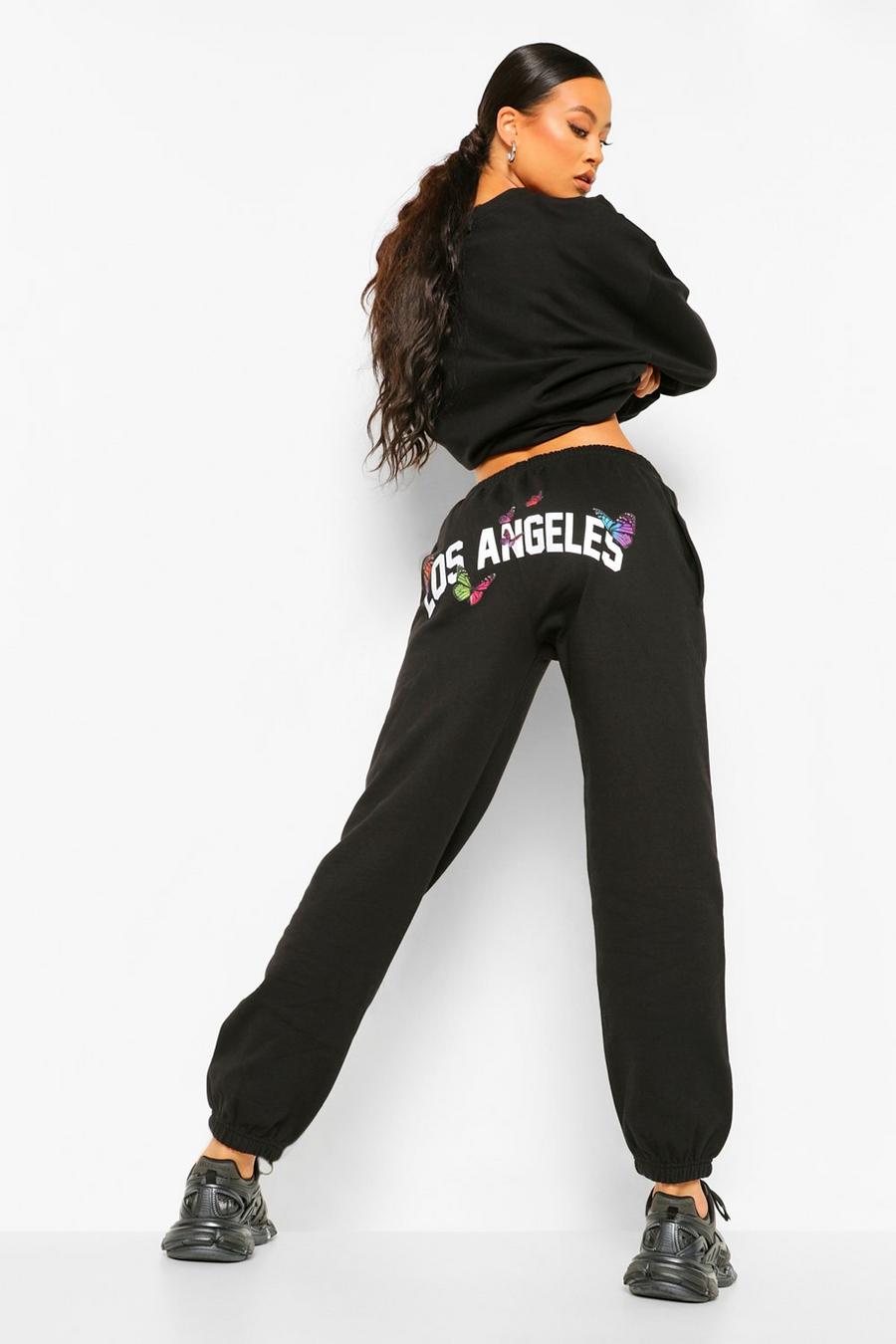 Pantaloni tuta con stampa posteriore con farfalle e scritta Los Angeles , Nero image number 1