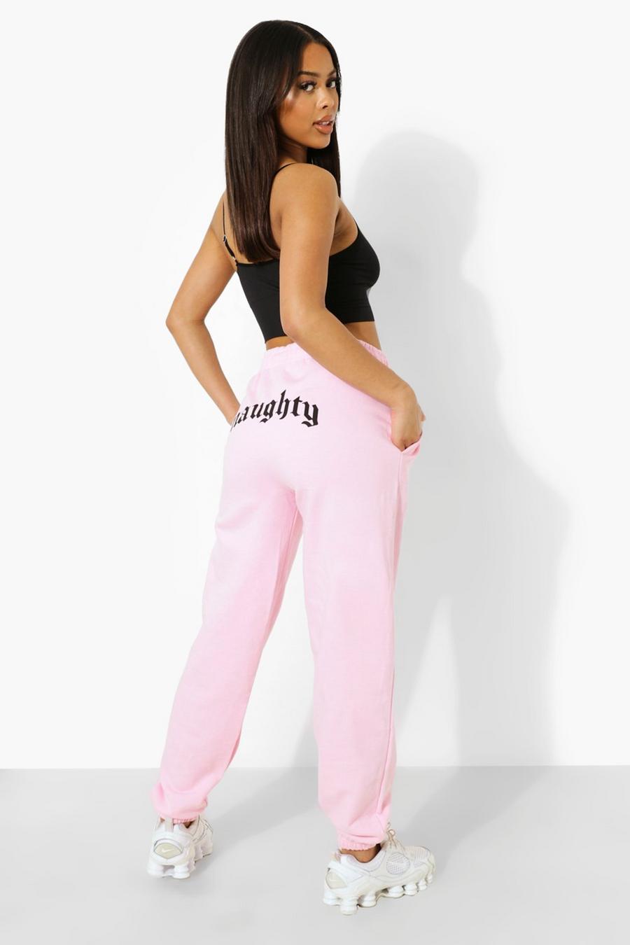 Pantaloni tuta con scritta Naughty sui glutei, Rosa pallido image number 1
