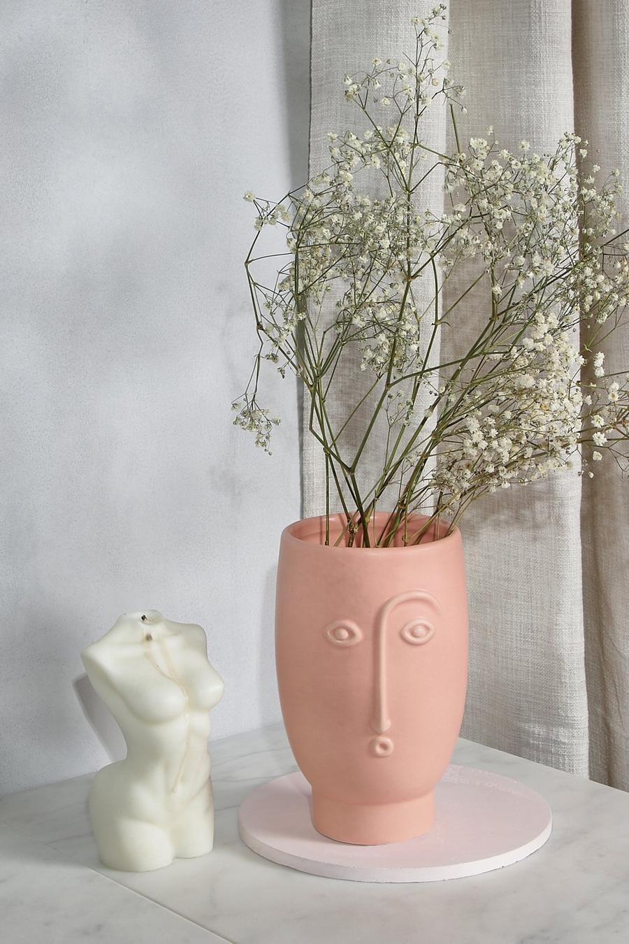 Vaso per piante rosa opaco con viso in rilievo image number 1