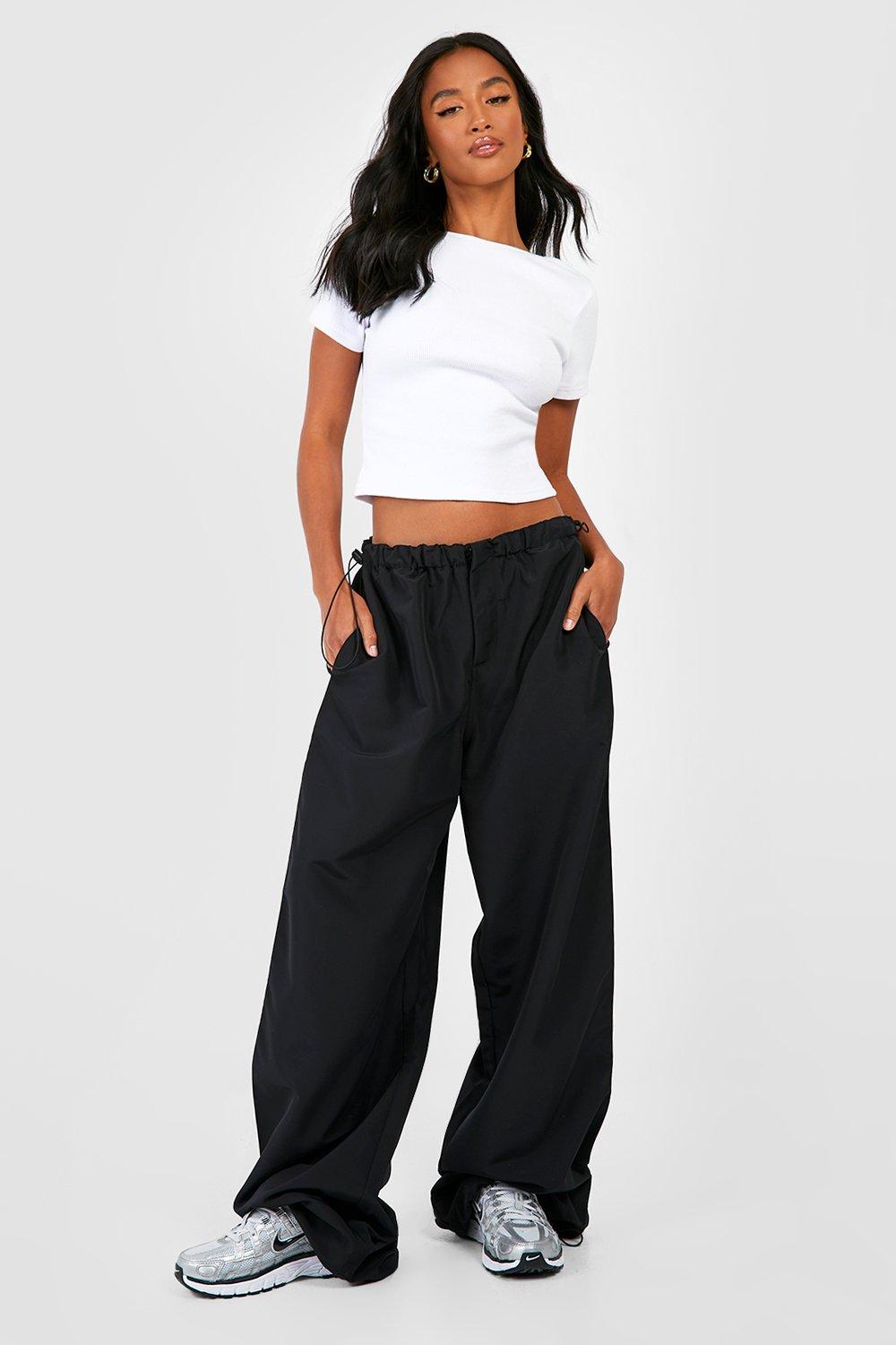 Premium Photo  A woman in a white top and cargo pants stands in