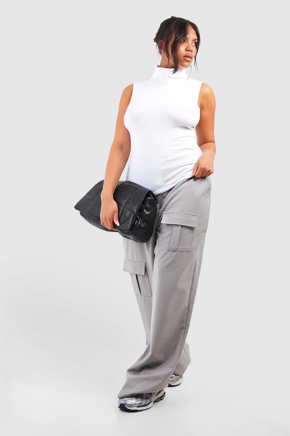 Premium Photo  A woman in a white top and cargo pants stands in