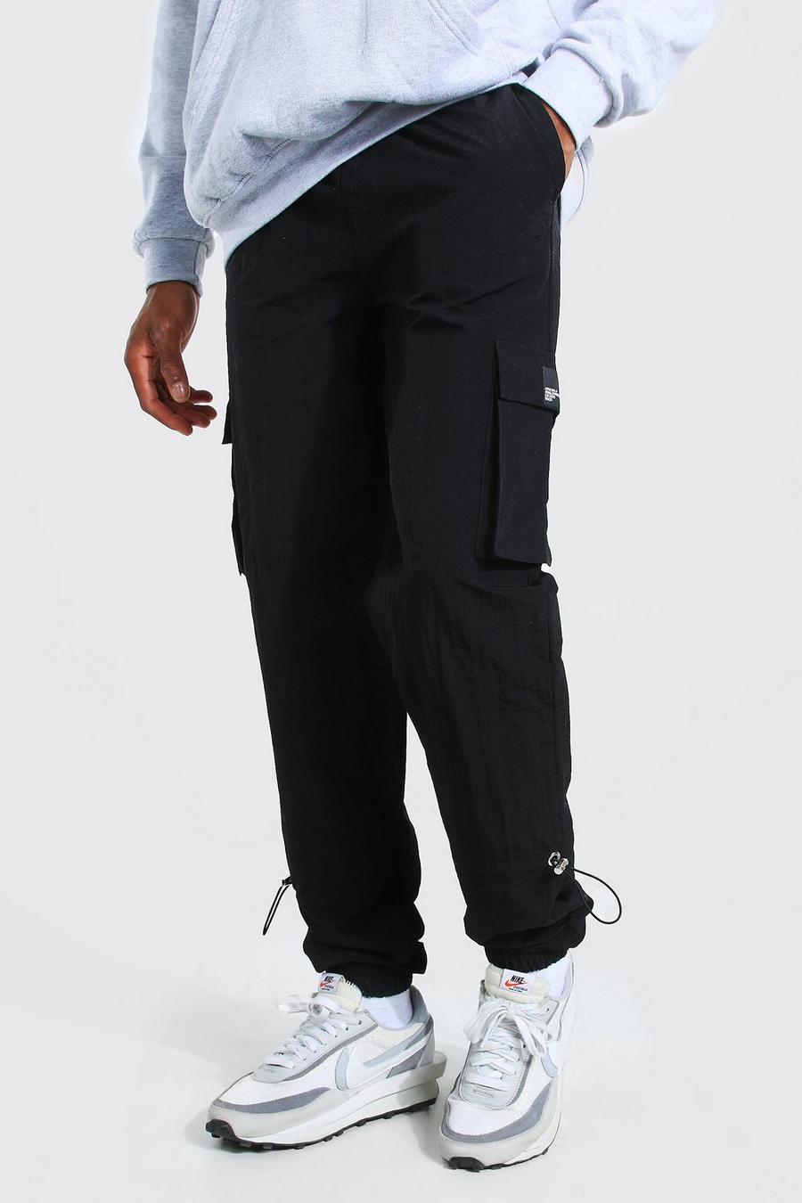 Pantaloni cargo con orlo elasticizzato, rivestimento effetto stropicciato e linguetta MAN, Nero image number 1
