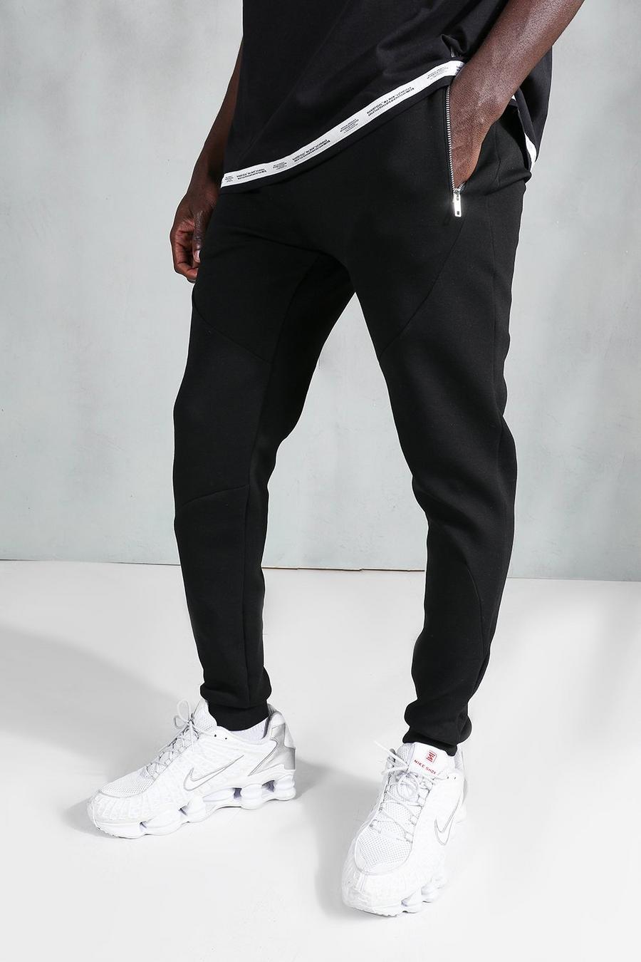 שחור מכנסי ריצה סקיני עם עיטור של פאנל תפרים ורוכסן image number 1