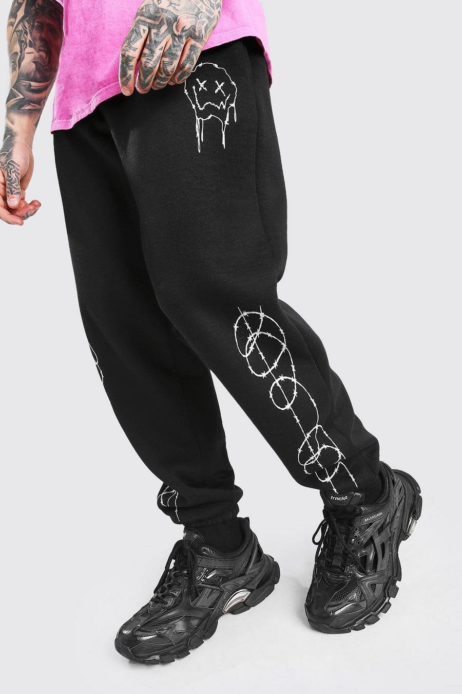 Black Joggers med droppande smiley och taggtråd samt ledig passform image number 1