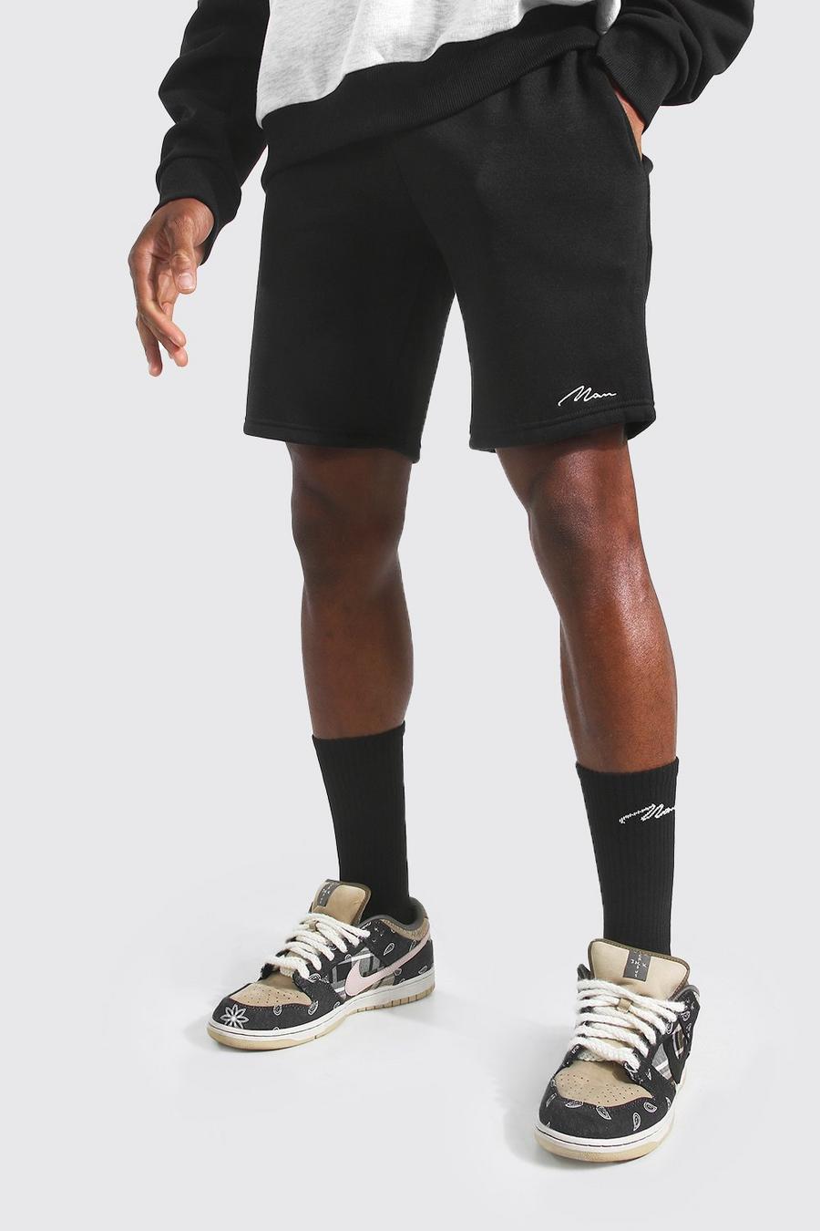 Pantalones cortos de largo medio ajustados de punto con firma Man, Negro image number 1