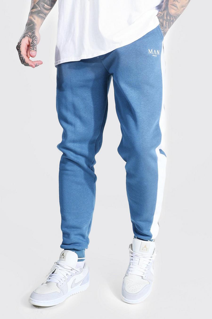 Pantaloni tuta skinny con pannelli, nervature e scritta Man a caratteri romani sul fondo gamba, Azzurro image number 1