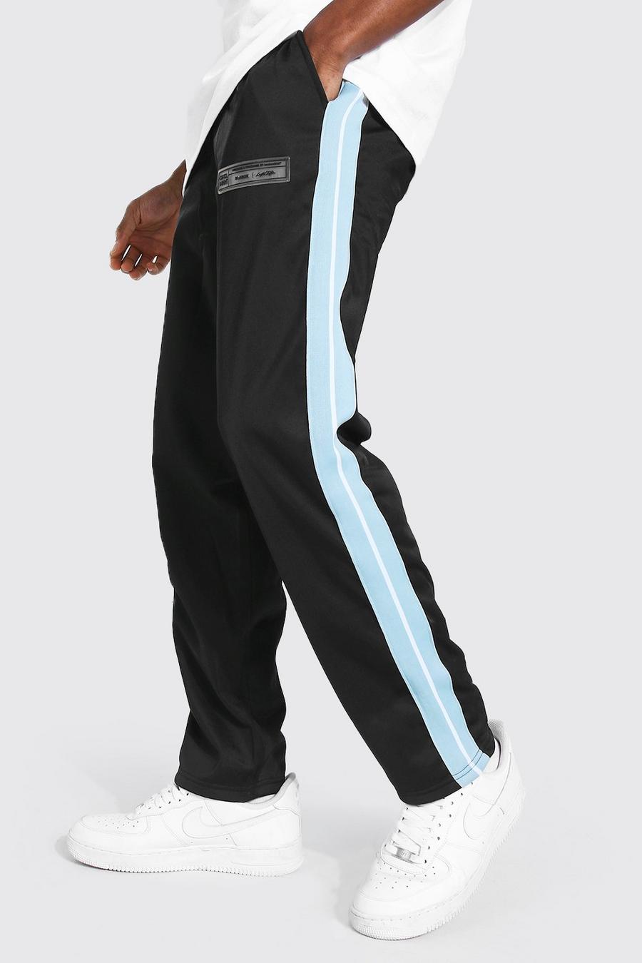 Pantalón deportivo de tejido por urdimbre holgado con franja lateral, Negro image number 1