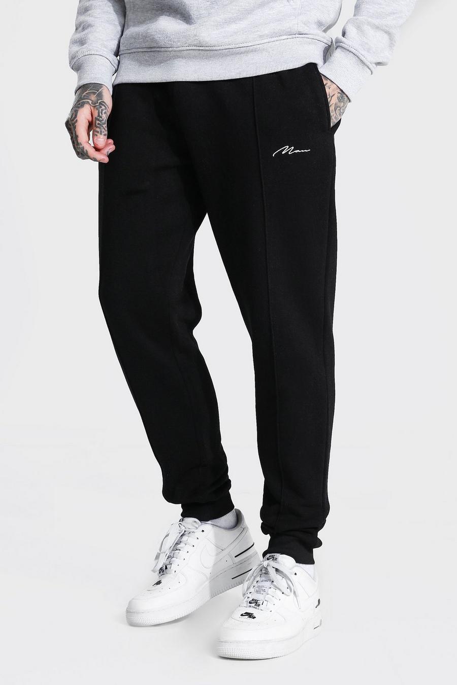 Pantalones de deporte ajustados de pinza con forro polar de la firma MAN, Negro image number 1