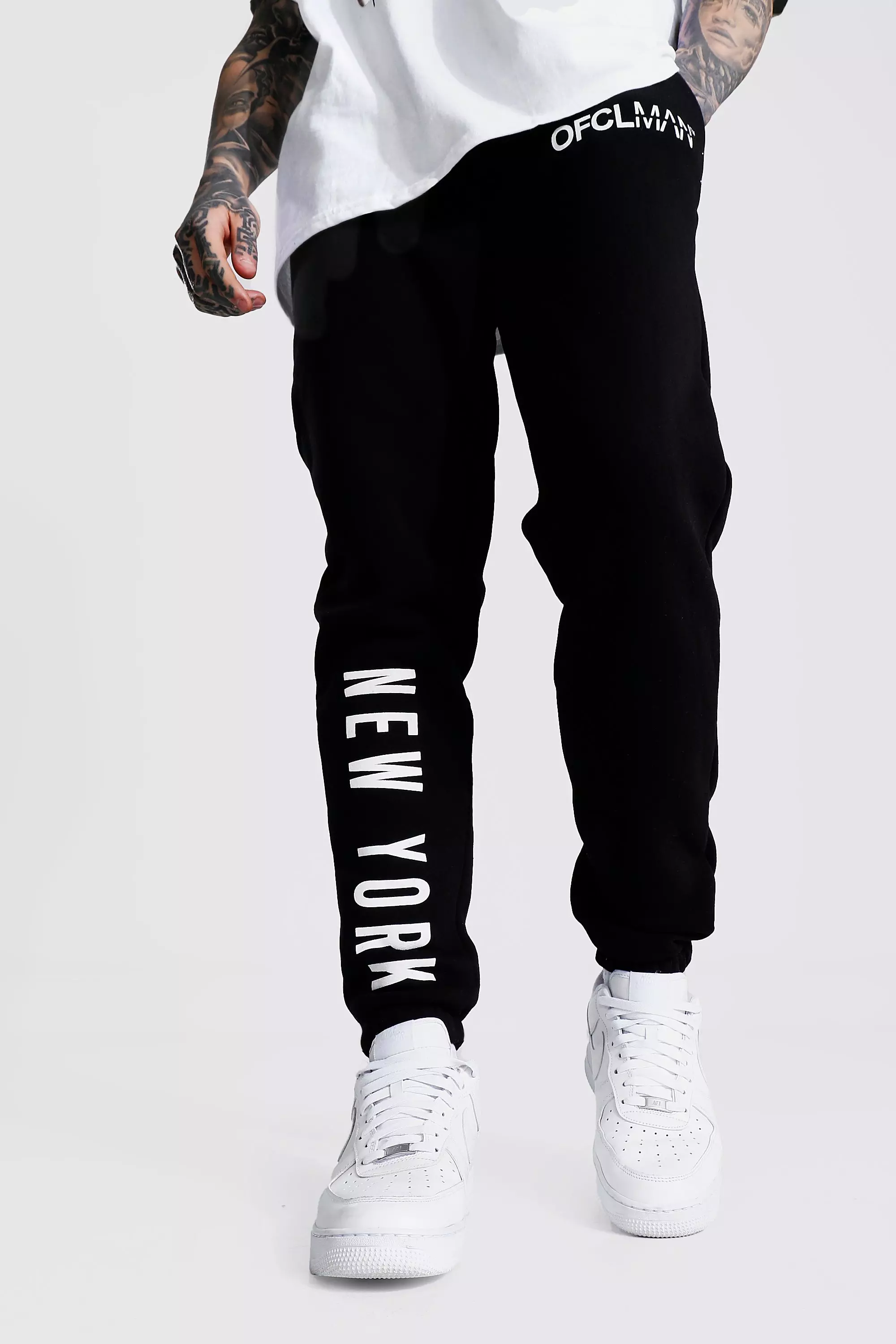 White joggers 2025 with black writing