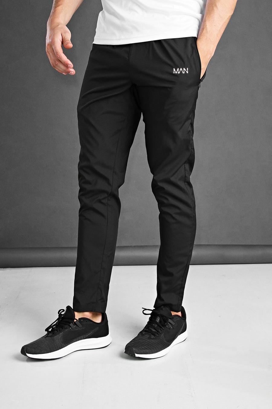 שחור מכנסי ריצה ארוגים בגזרת סקיני לאימונים עם כיתוב MAN image number 1