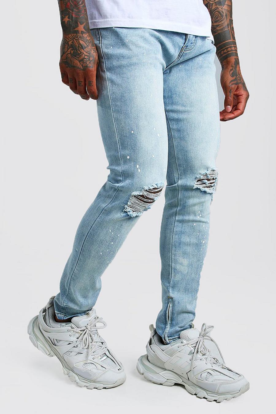 כחול בהיר סקיני ג'ינס עם כתמי צבע וקרסוליים רכוסים image number 1