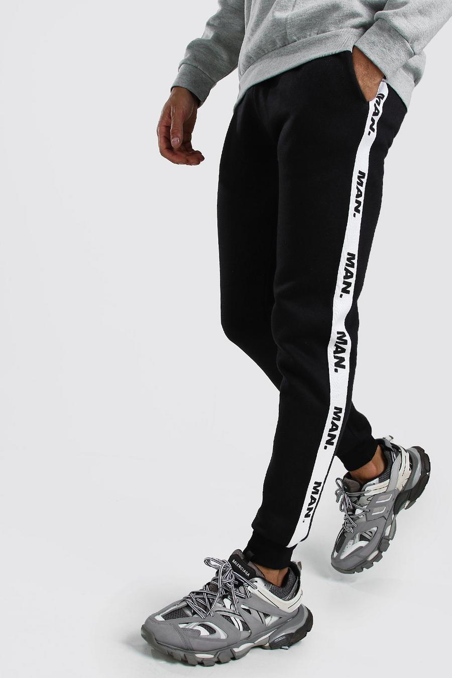 Black Skinny Fit Track Pants With Man Repeat Tape image number 1