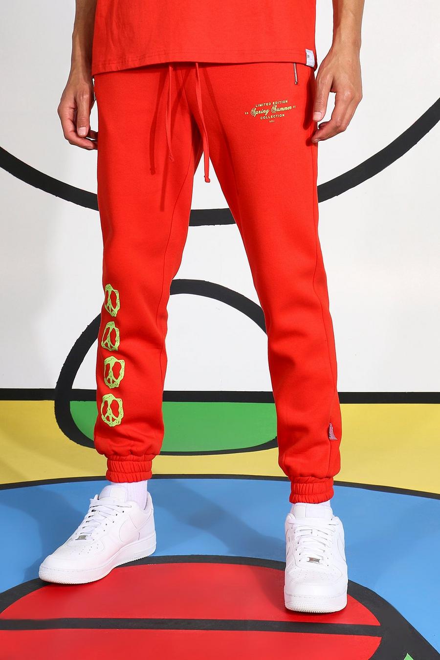 Pantaloni tuta Tall con stampa laterale di simboli della pace fluo, Rosso image number 1