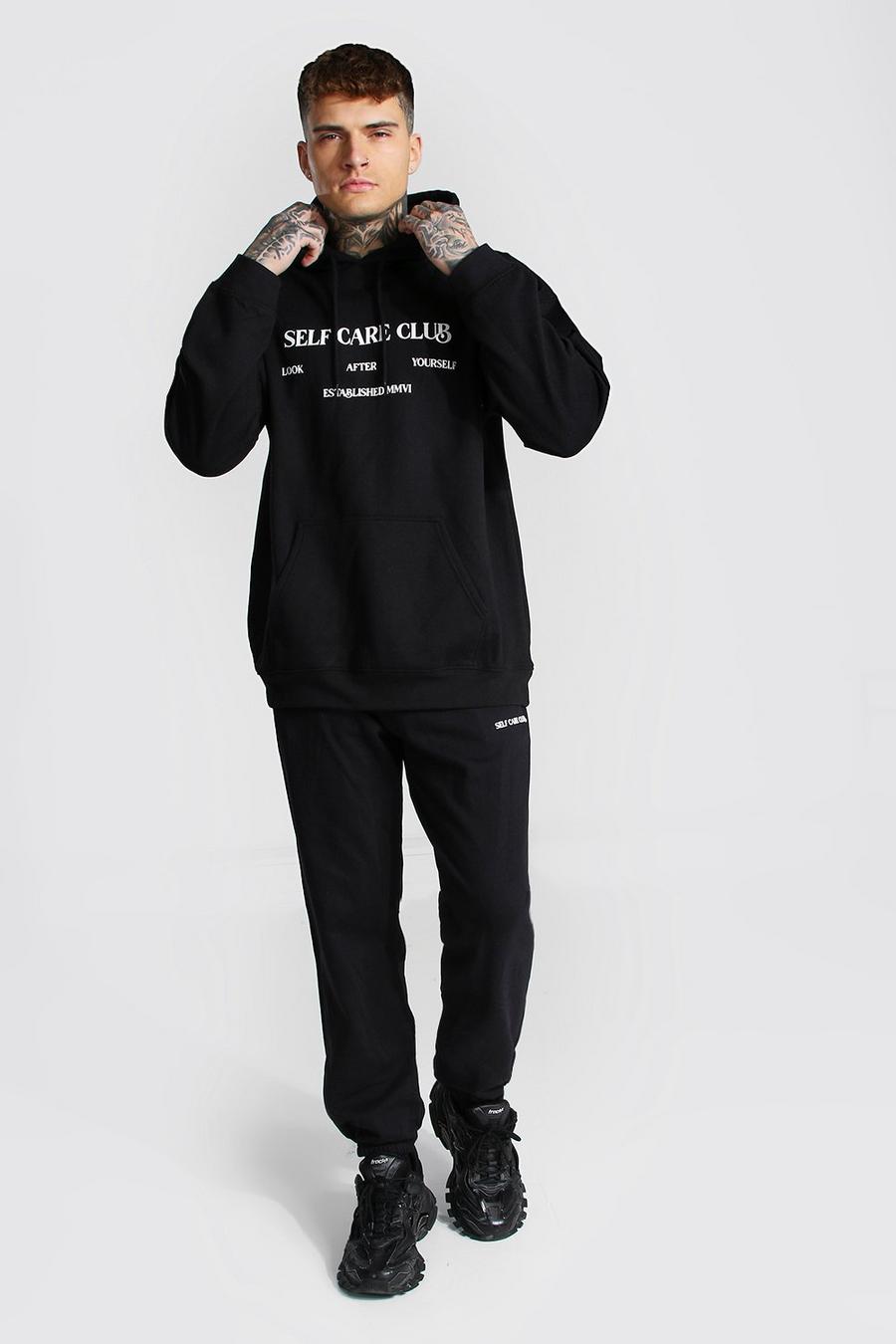 שחור חליפת טרנינג עם קפוצ'ון אוברסייז עם כיתוב Self Care Club image number 1