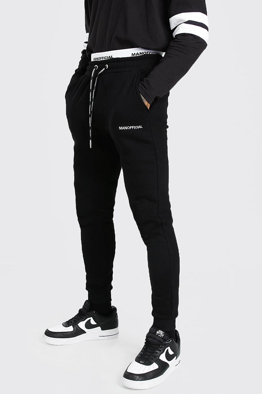 שחור מכנסי ריצה בגזרת סקיני עם רצועת מותן כפולה והכיתוב MAN Official image number 1