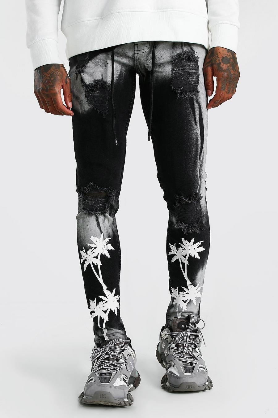 שחור מכנסי ג'ינס מולבנים בגזרת סופר סקיני עם קרעים והדפס דקלים image number 1