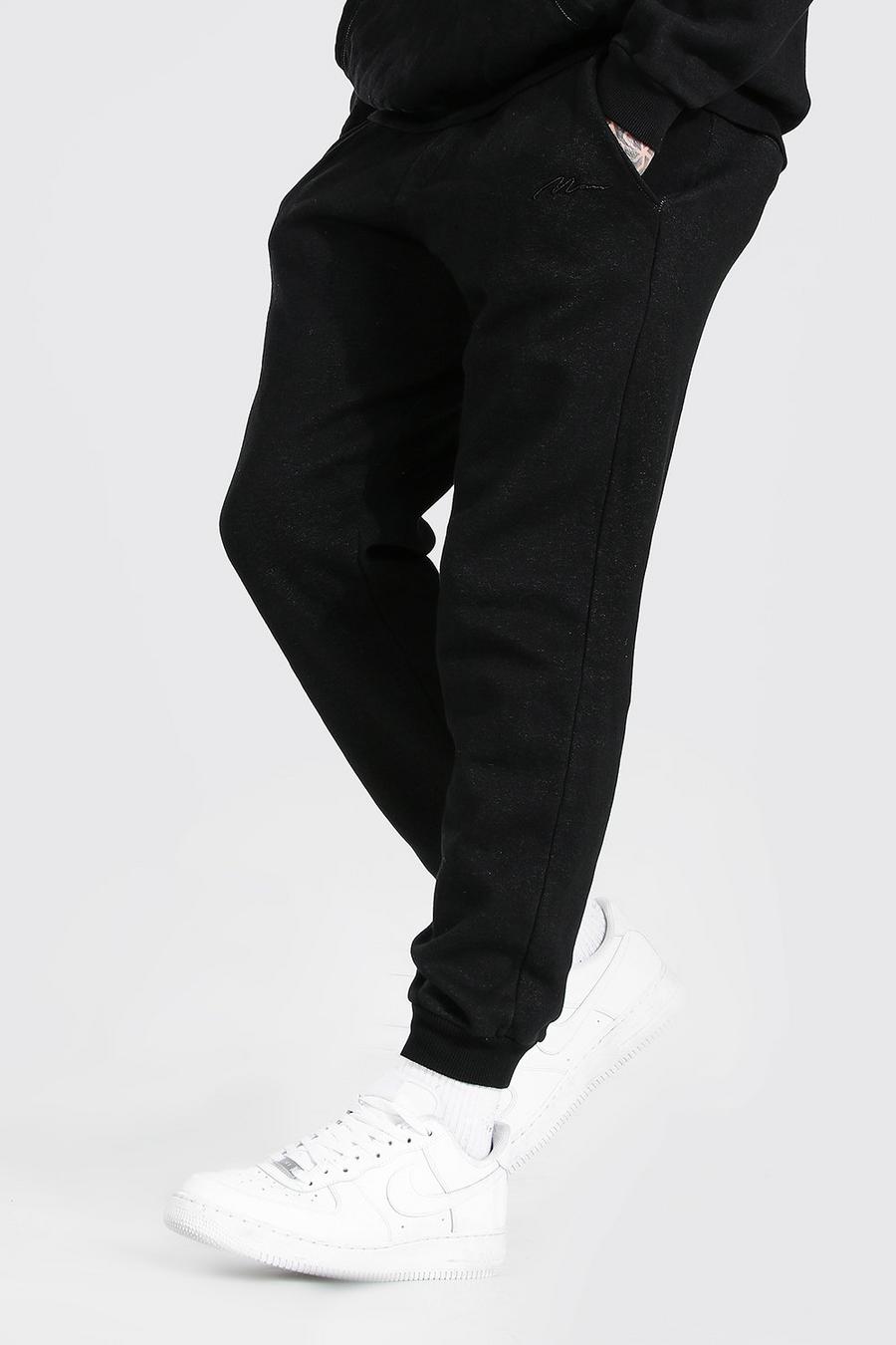 Pantaloni tuta taglio regular effetto consumato con firma MAN, Nero effetto lavato image number 1