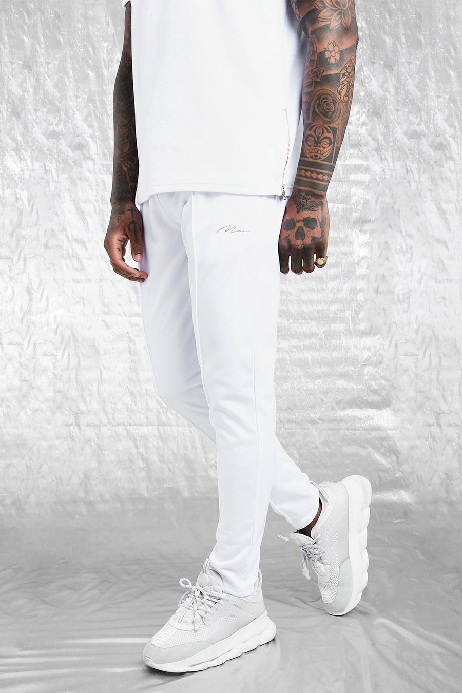 Pantaloni tuta bianco e oro skinny in tricot con pinces e scritta MAN image number 1