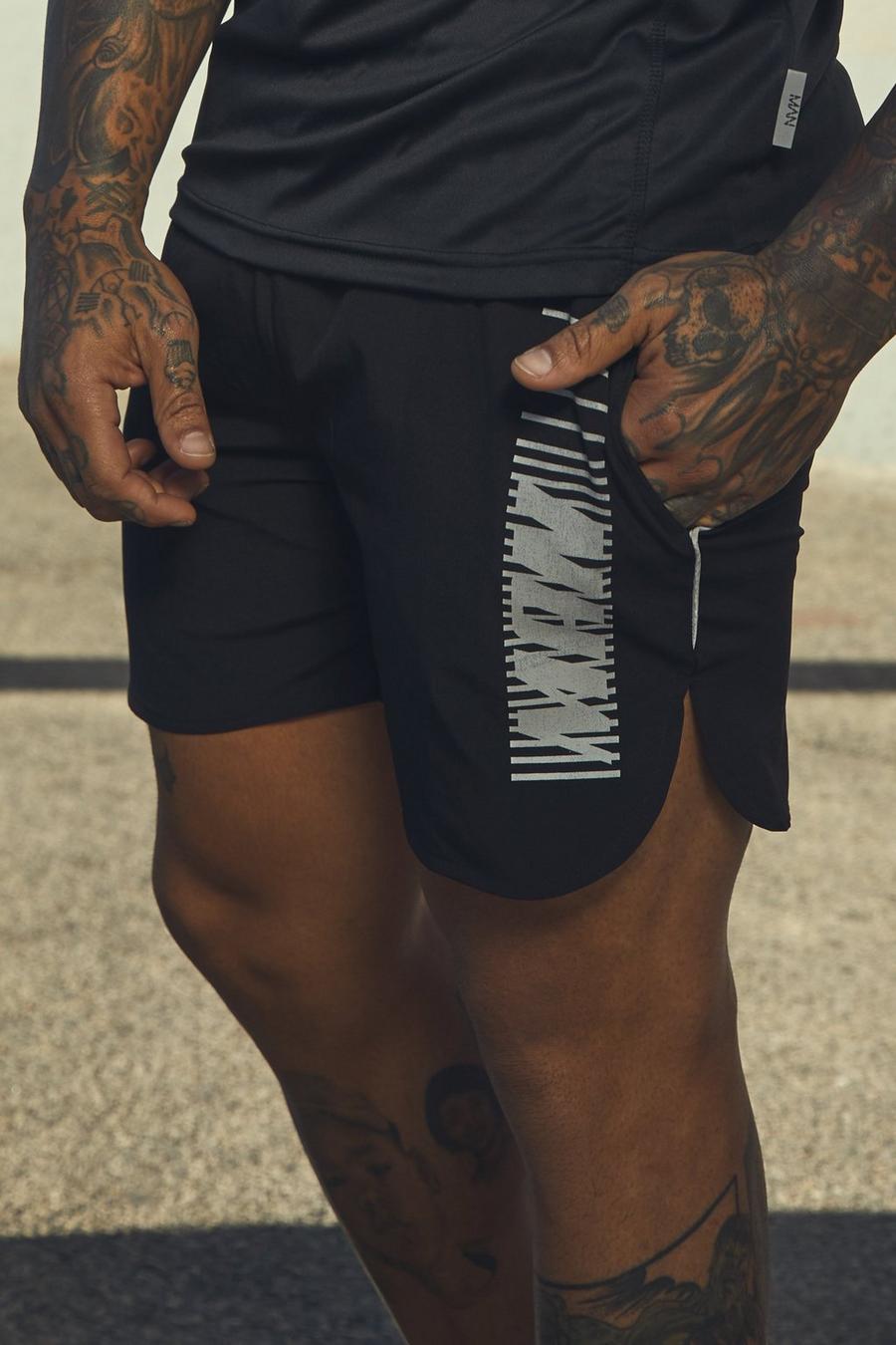 Pantalones cortos activos de correr con estampado MAN, Negro image number 1