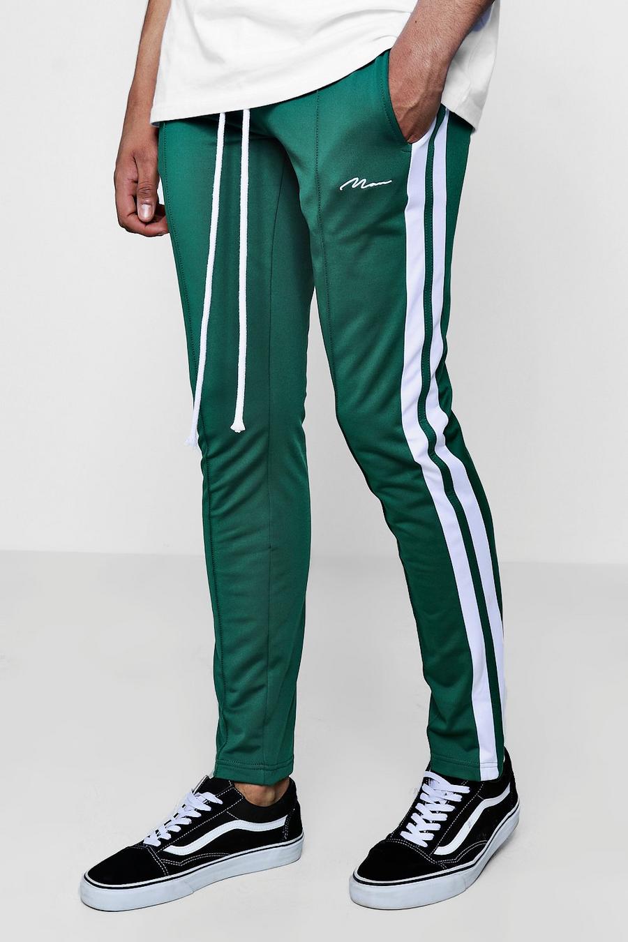 Pantalones de deporte marca "MAN" de corte skinny con lateral image number 1