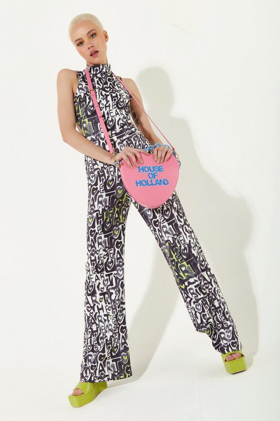 Heart Shape Cross Body Bag In Pink With A Chain Detail And Printed Logo