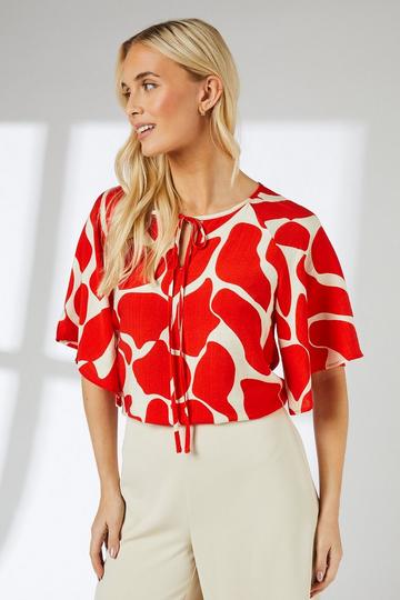 Abstract Print Tie Neck Top red