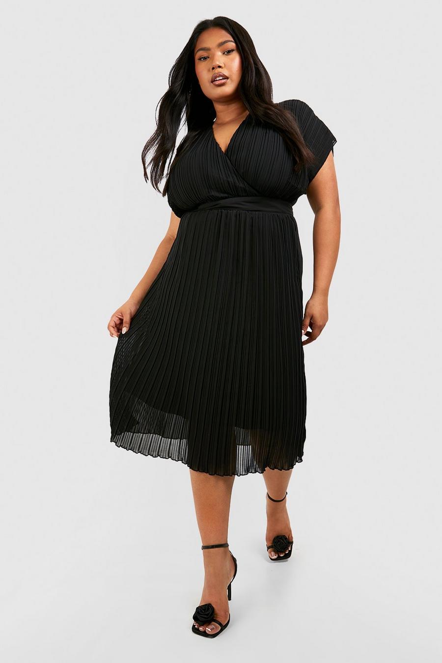Close up of young beautiful plus size model in black dress, xxl woman in  blurred studio background Stock Photo