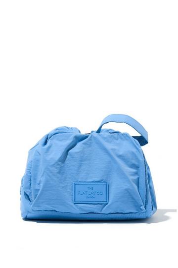 The Flat Lay Co. Drawstring Makeup Bag in Blue Parachute multi